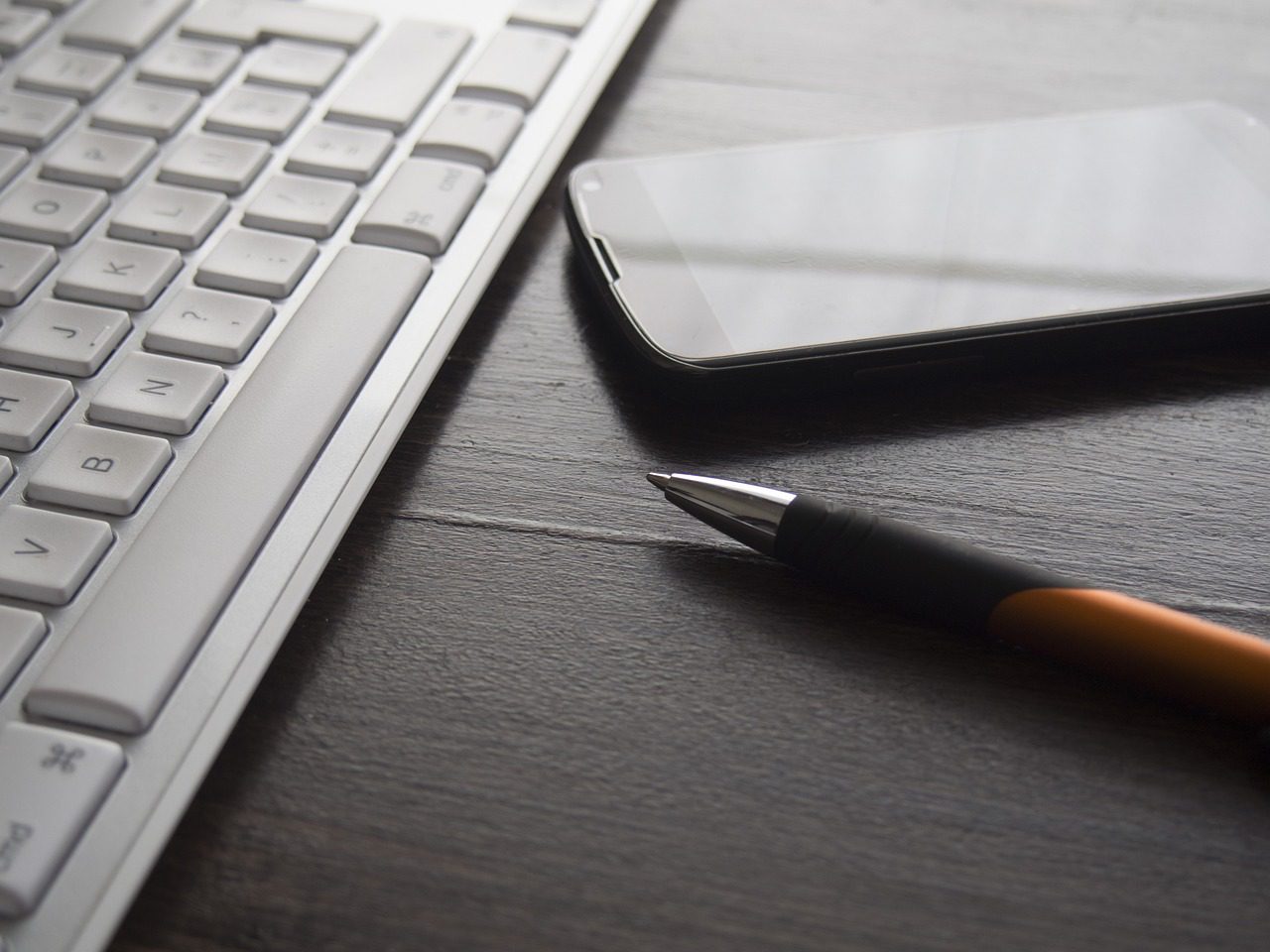 keyboard, pen, phone. "Contact us" Hero picture